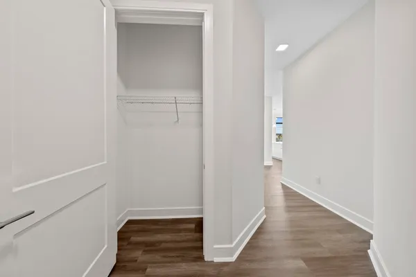 a view of hallway with wooden floor