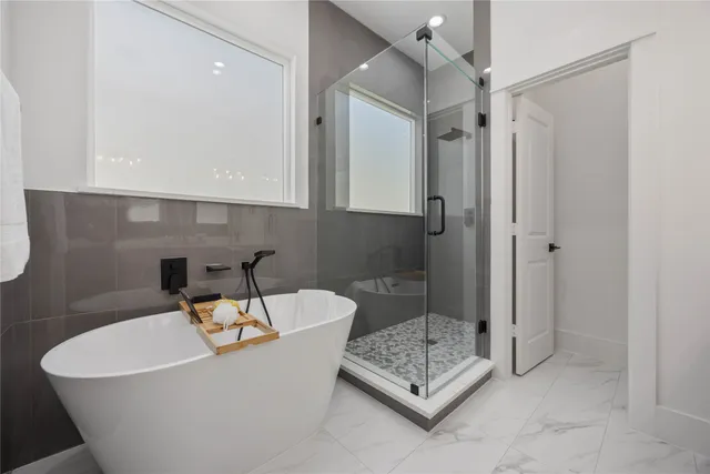 a bathroom with a bathtub and shower