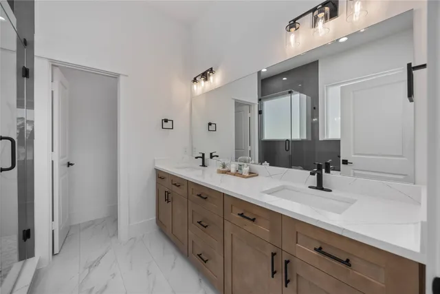 a bathroom with a double vanity sink mirror and double
