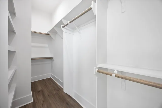 a view of walk in closet with empty racks