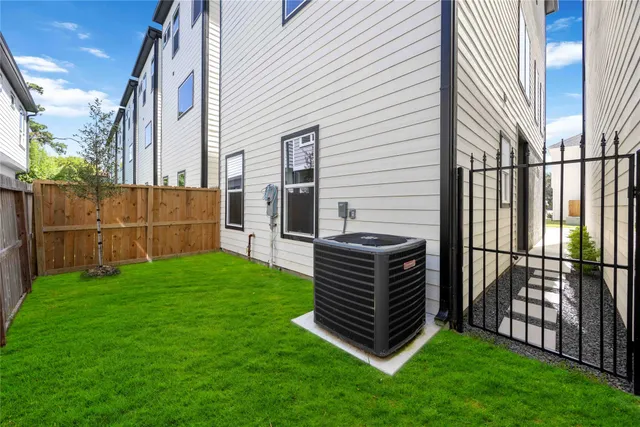 a view of a backyard with wooden fence