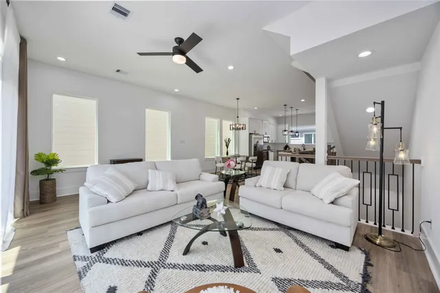 a living room with furniture and a chandelier