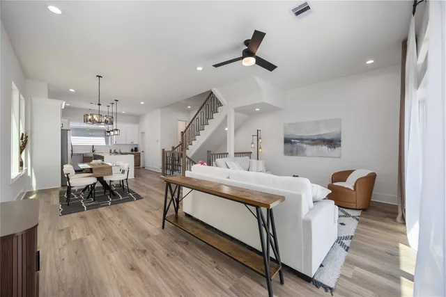 a living room with furniture and a wooden floor