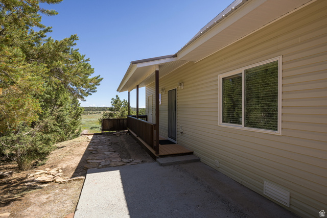 684 Blue Mountain Ridge Monticello, UT 84535 - Photo 55 of 71 View of side of home with a deck and crawl space