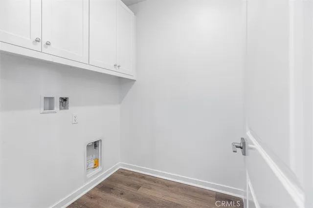 a view of a kitchen with white cabinets and a wooden floor