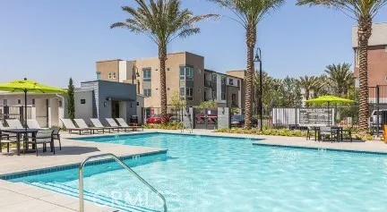 a view of a house with swimming pool and sitting area