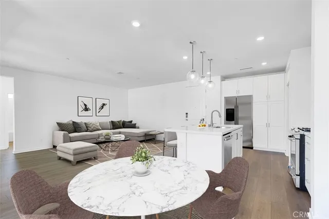 a living room with kitchen island furniture and a chandelier