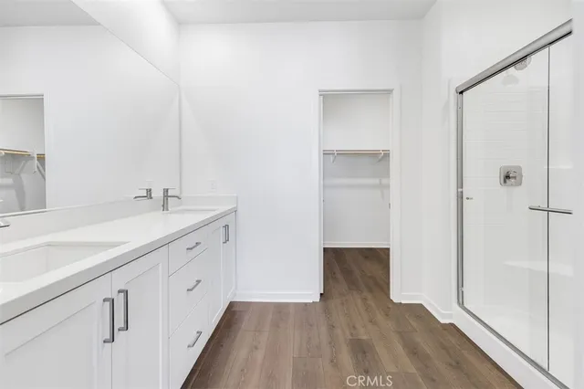a spacious bathroom with a double vanity sink and mirror