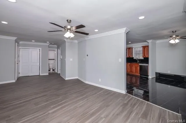 a view of an empty room with closet and a window
