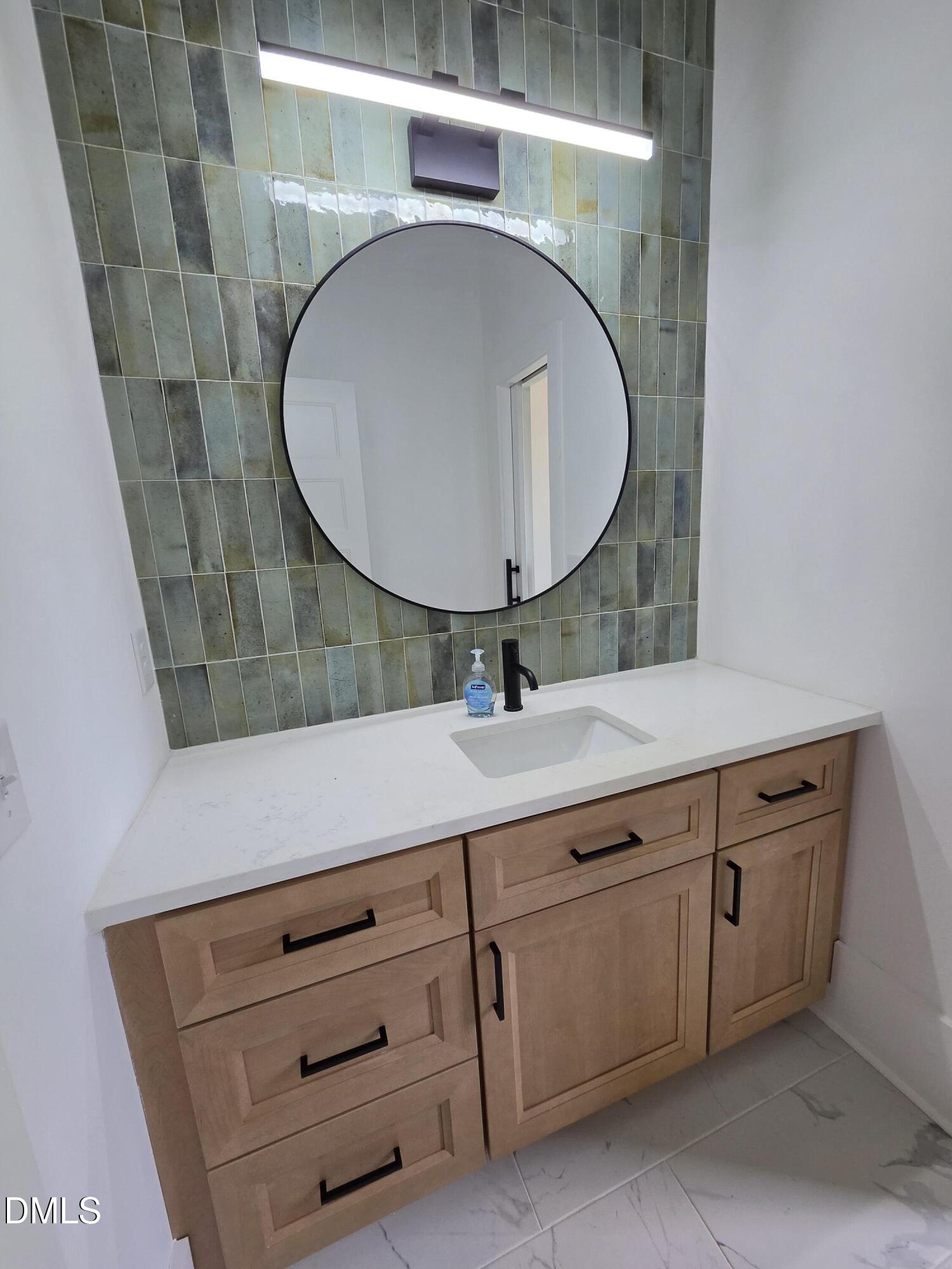 712 Van Buren Road Raleigh, NC 27604 - Photo 20 of 34 a bathroom with a sink mirror and vanity