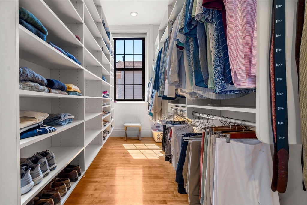 44 Pleasant Street, Unit 1 Marblehead, MA 01945 - Photo 19 of 35 a view of walk in closet with clothes and shoes