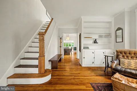 a view of living room kitchen with furniture and wooden floor
