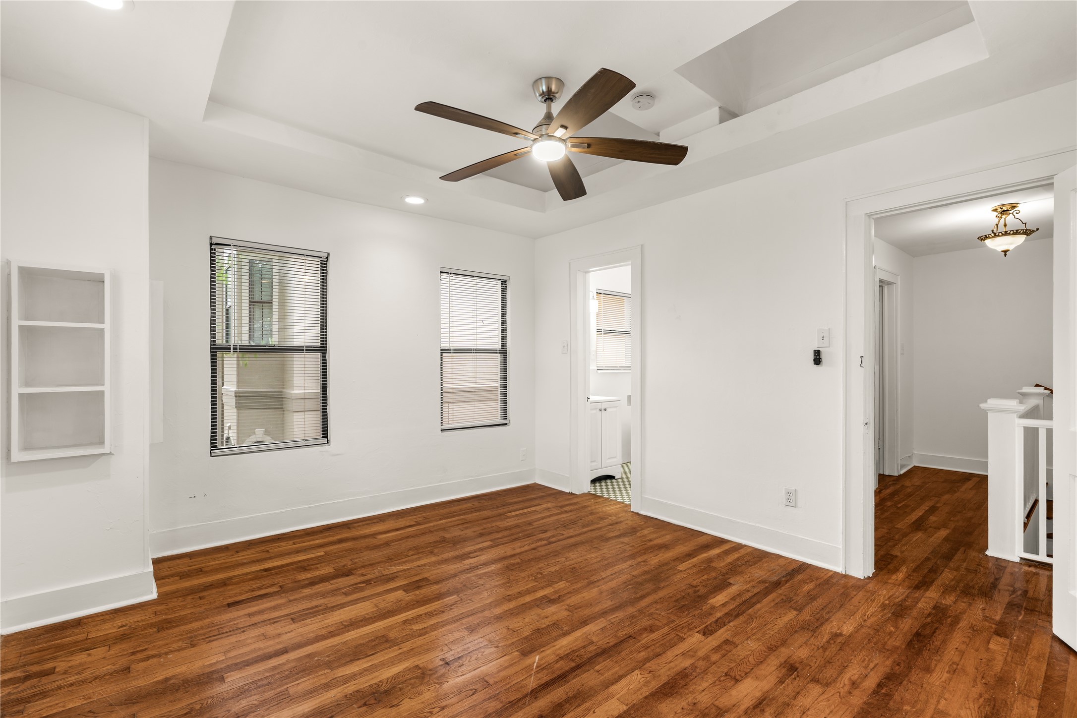2202 West Main Street Houston, TX 77098 - Photo 21 of 32 a view of empty room with wooden floor and fan