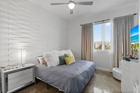 a bedroom with a bed dresser and a window