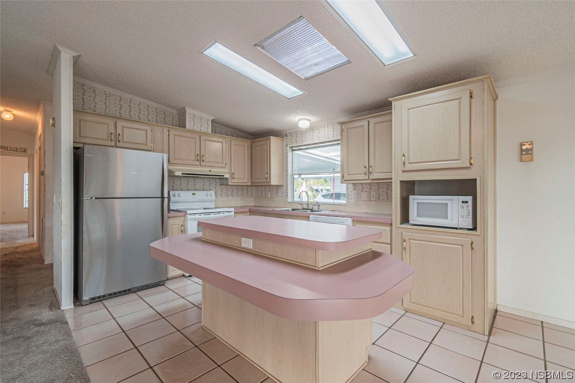 333 Schooner Avenue Edgewater, FL 32141 - Photo 11 of 31 a kitchen with stainless steel appliances granite countertop a refrigerator and a stove top oven