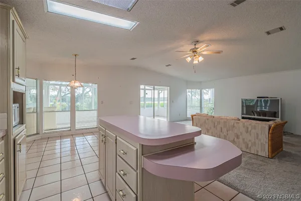 a living room with granite countertop furniture a fireplace and a chandelier