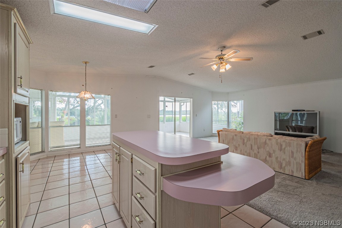 333 Schooner Avenue Edgewater, FL 32141 - Photo 12 of 31 a living room with granite countertop furniture a fireplace and a chandelier