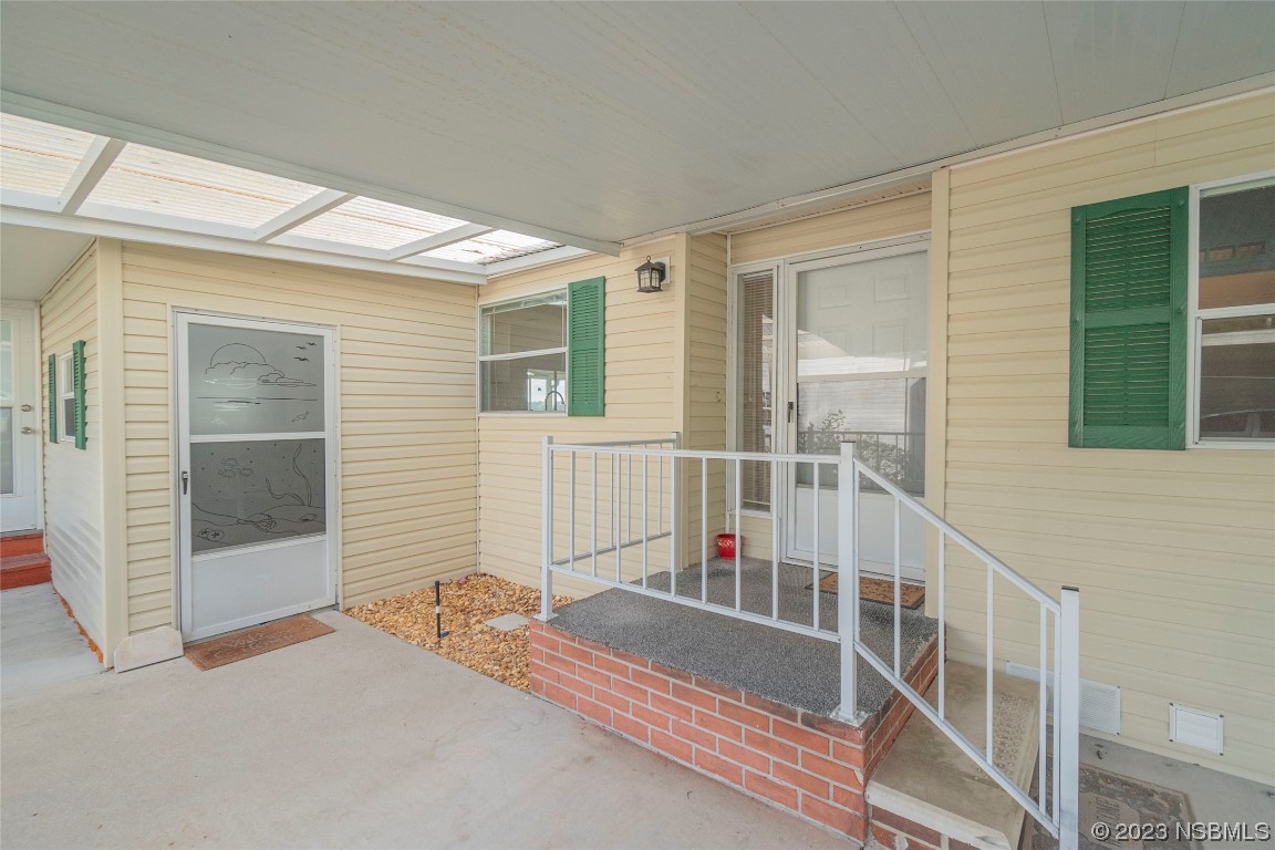 333 Schooner Avenue Edgewater, FL 32141 - Photo 2 of 31 a view of a balcony with wooden floor and fence