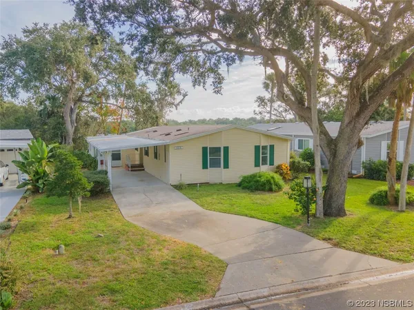 a view of a house with a yard and tree s