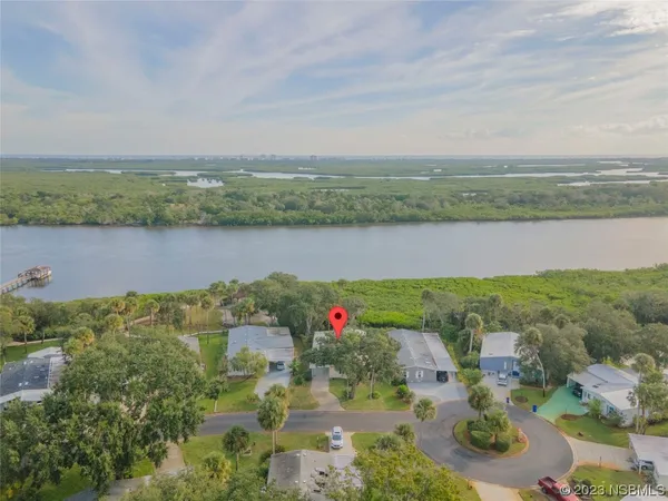 an aerial view of lake and residential houses with outdoor space