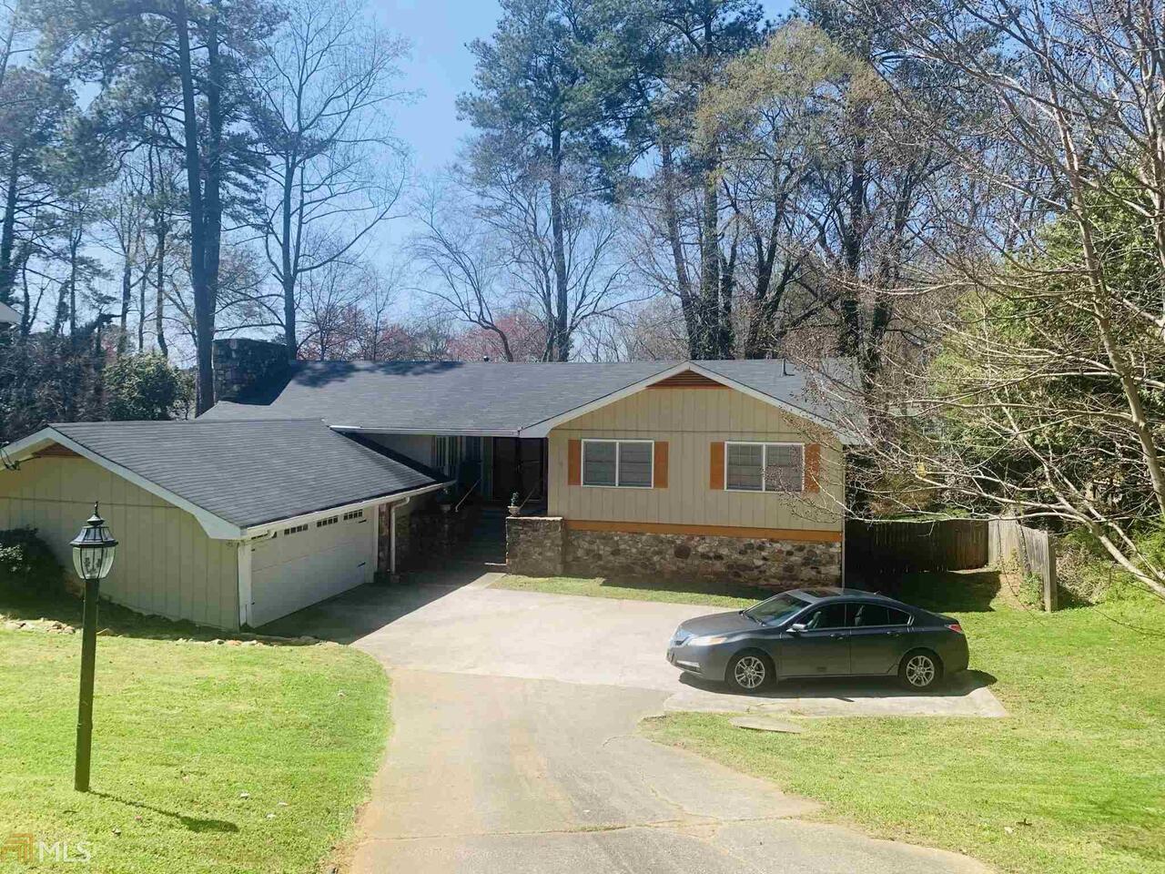 a view of a house with a yard and sitting area