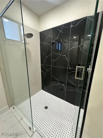 a bathroom with a shower and a mirror
