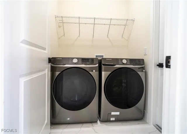 a view of a storage & utility room with a washer and dryer
