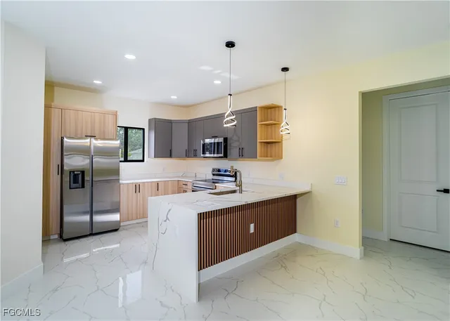 a large kitchen with cabinets and stainless steel appliances