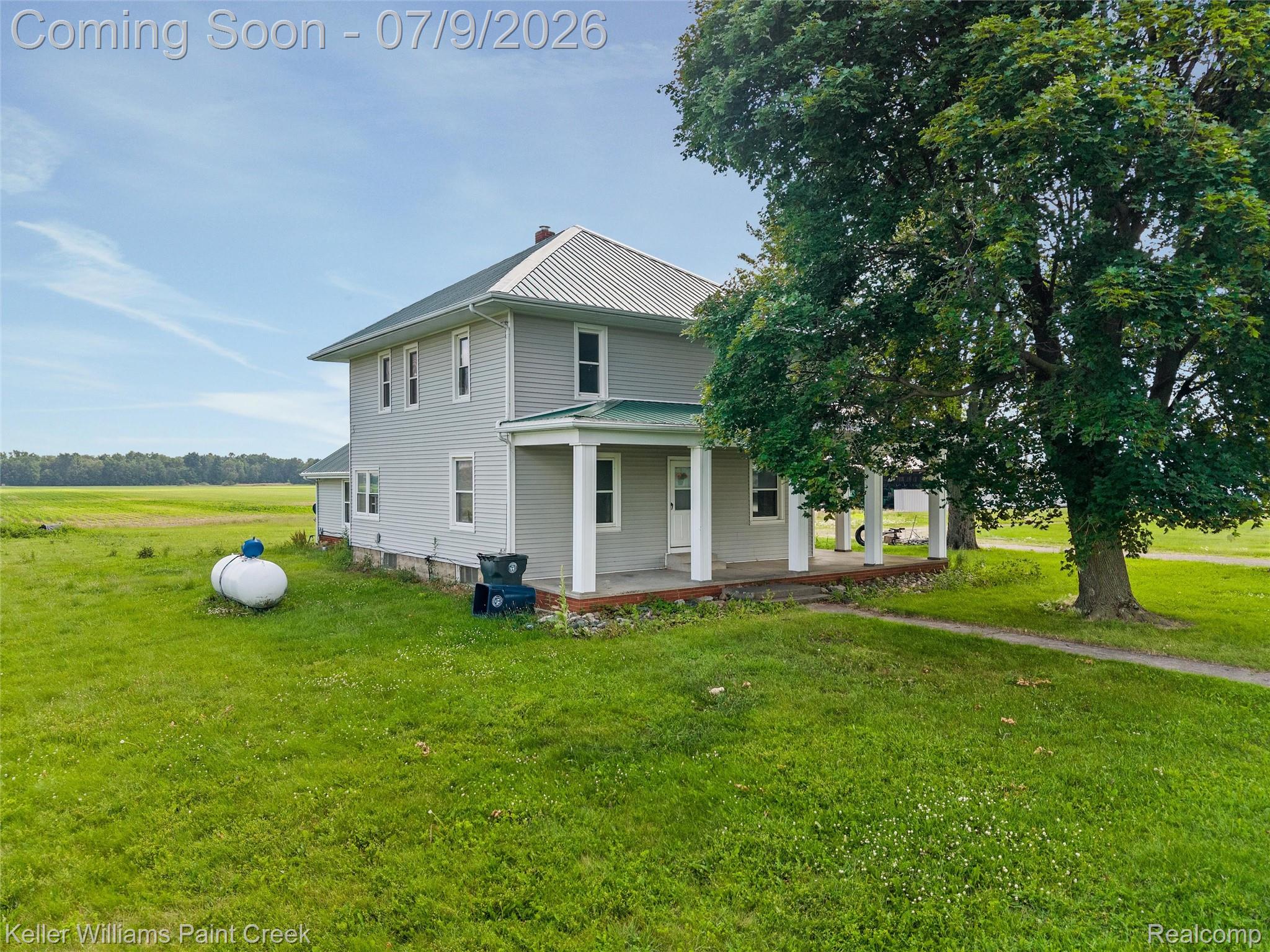 28780 School Section Road Richmond, MI 48062 - Photo 41 of 50 Two-story residence featuring light gray siding, a metal roof, and a covered front porch with white pillars