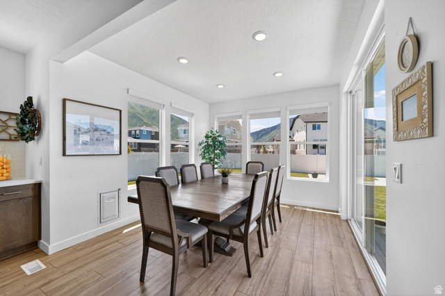1165 West Union Bench Drive Mapleton, UT 84664 - Photo 17 of 61 Dining area featuring a large wood-finish table, recessed lighting, and wood-look plank flooring