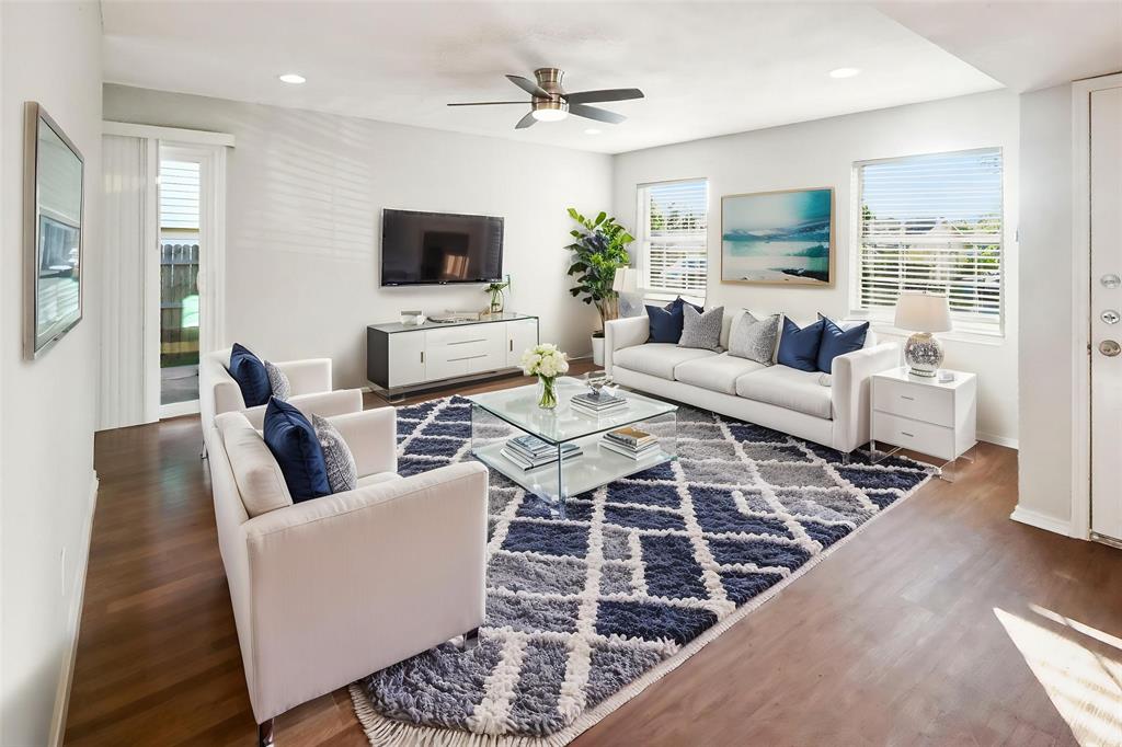 a living room with furniture wooden floor and a flat screen tv