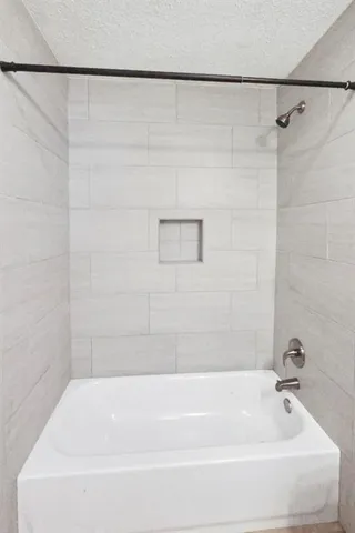 a bathroom with a shower and a bath tub