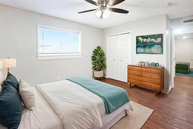 a bedroom with a bed and a dresser