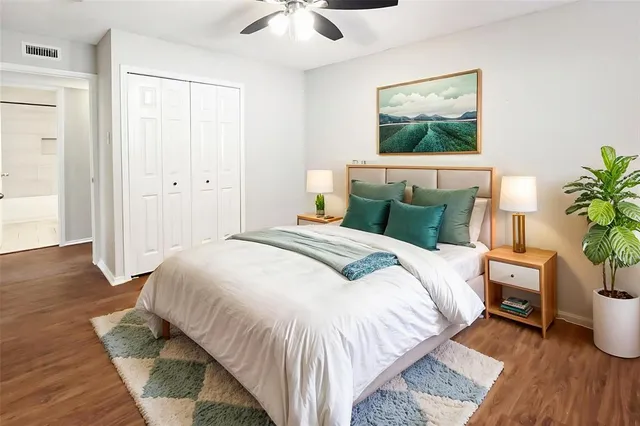 a bedroom with a bed and a potted plant