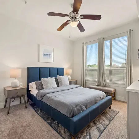 a bedroom with bed and a large window