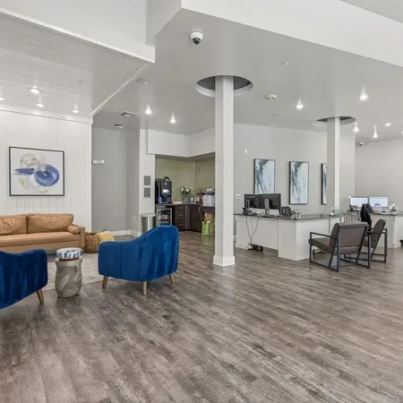 a living room with furniture and kitchen view