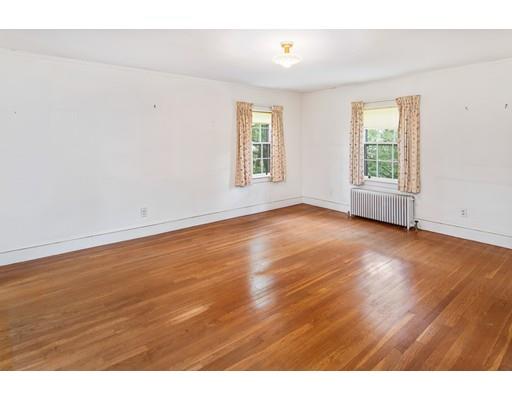 95 Leland Road Boston, MA 02467 - Photo 12 of 20 an empty room with wooden floor and windows