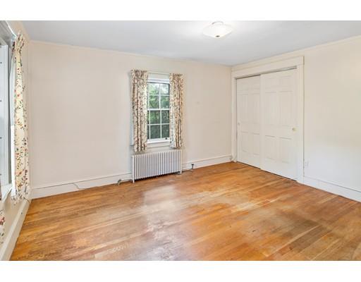 95 Leland Road Boston, MA 02467 - Photo 14 of 20 an empty room with wooden floor and windows