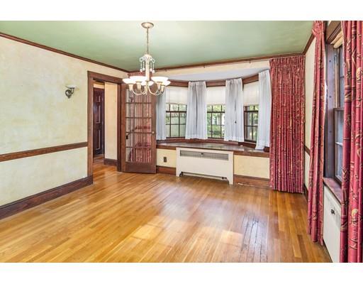 95 Leland Road Boston, MA 02467 - Photo 4 of 20 a living room with furniture and a chandelier