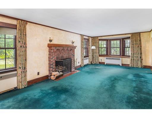 95 Leland Road Boston, MA 02467 - Photo 6 of 20 a view of an empty room with a fireplace and a window