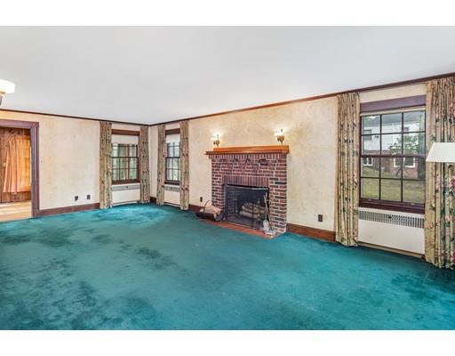 95 Leland Road Boston, MA 02467 - Photo 7 of 20 a view of an empty room with a fireplace and a window