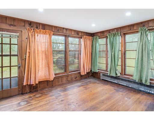 95 Leland Road Boston, MA 02467 - Photo 8 of 20 an empty room with wooden floor and windows