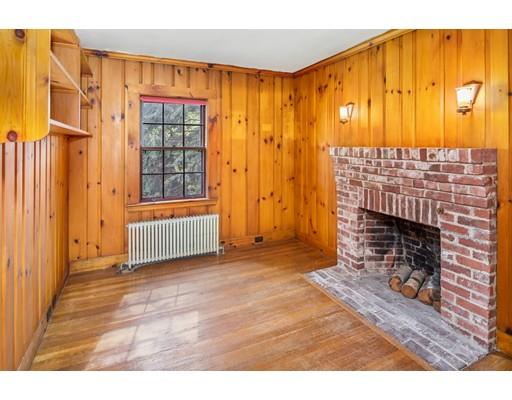 95 Leland Road Boston, MA 02467 - Photo 10 of 20 a living room with a fireplace furniture and a window