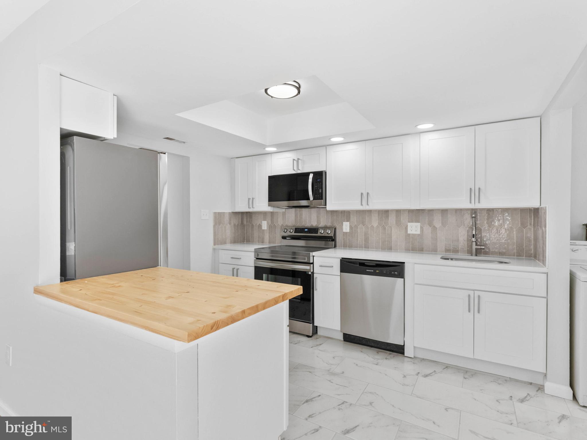 23 Roxborough Place Willingboro, NJ 08046 - Photo 8 of 23 a kitchen with a stove a sink and a refrigerator