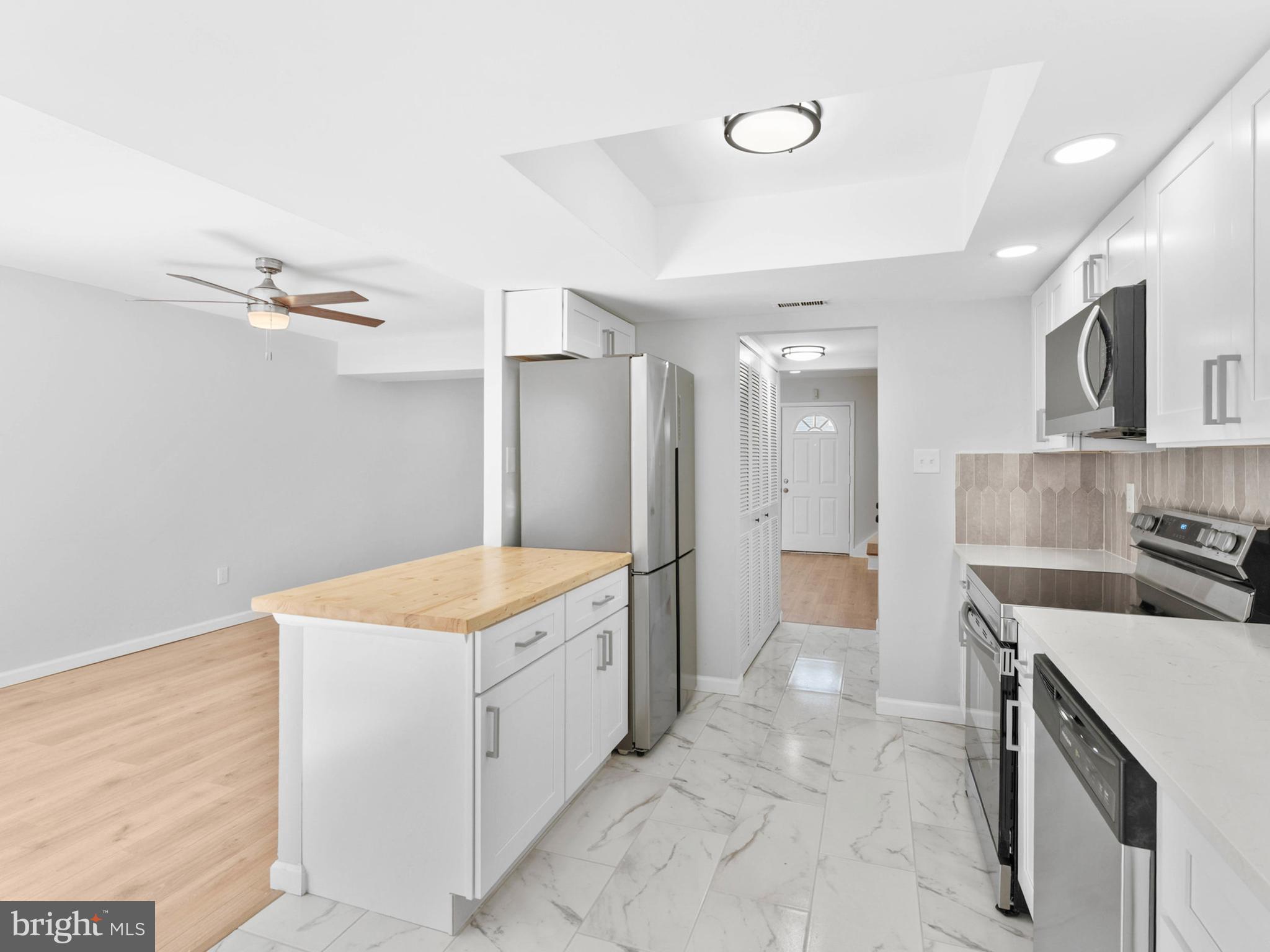 23 Roxborough Place Willingboro, NJ 08046 - Photo 9 of 23 a kitchen with a stove a sink and a refrigerator