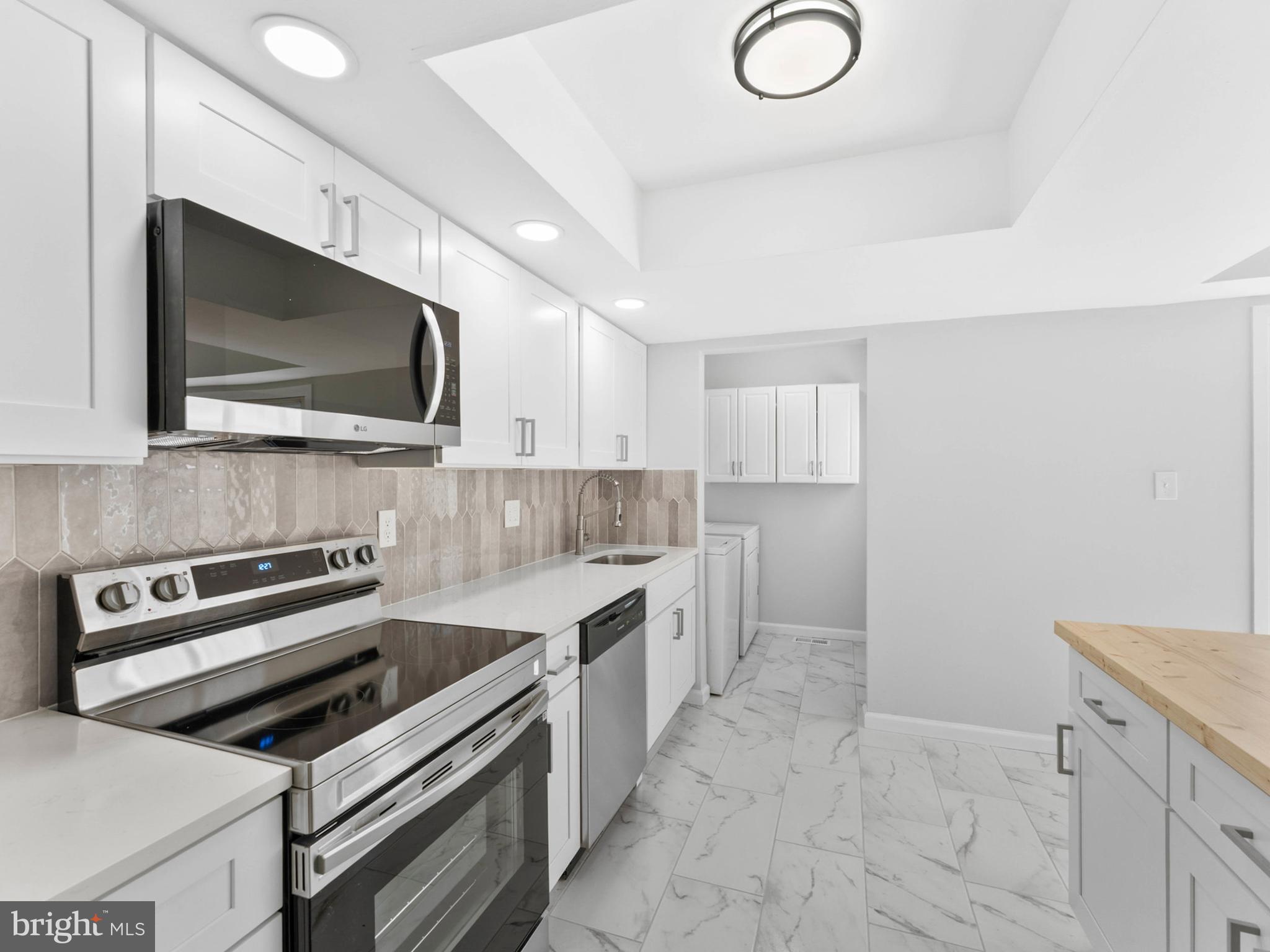 23 Roxborough Place Willingboro, NJ 08046 - Photo 10 of 23 a kitchen with a stove and a microwave