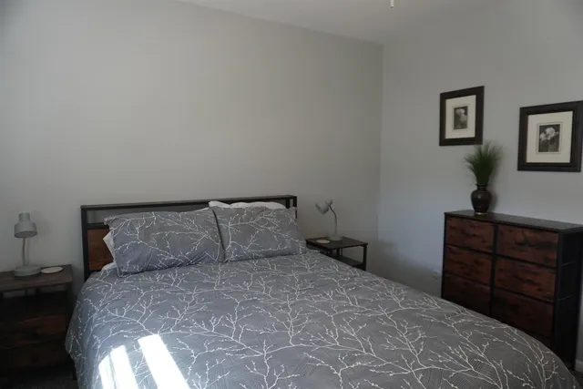 a bedroom with a bed and a dresser