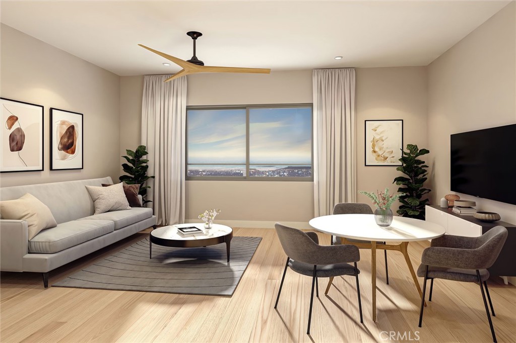 451 West Grand Avenue, Unit 212 Grover Beach, CA 93433 - Photo 2 of 8 a living room with furniture a flat screen tv and a large window