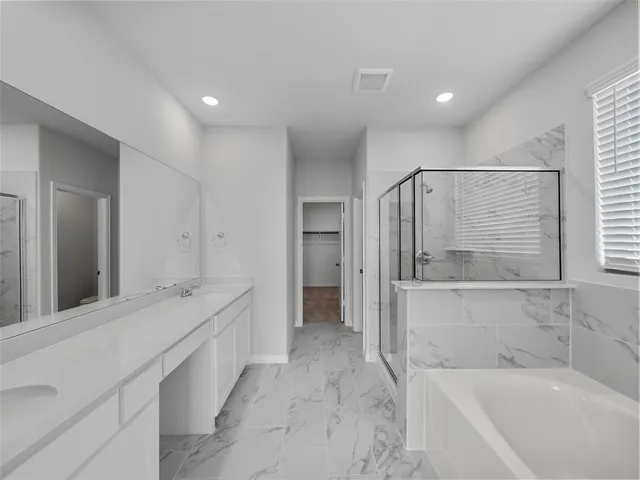 a bathroom with a bathtub and a sink