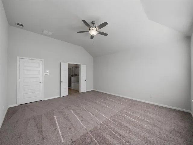 a view of empty room with ceiling fan